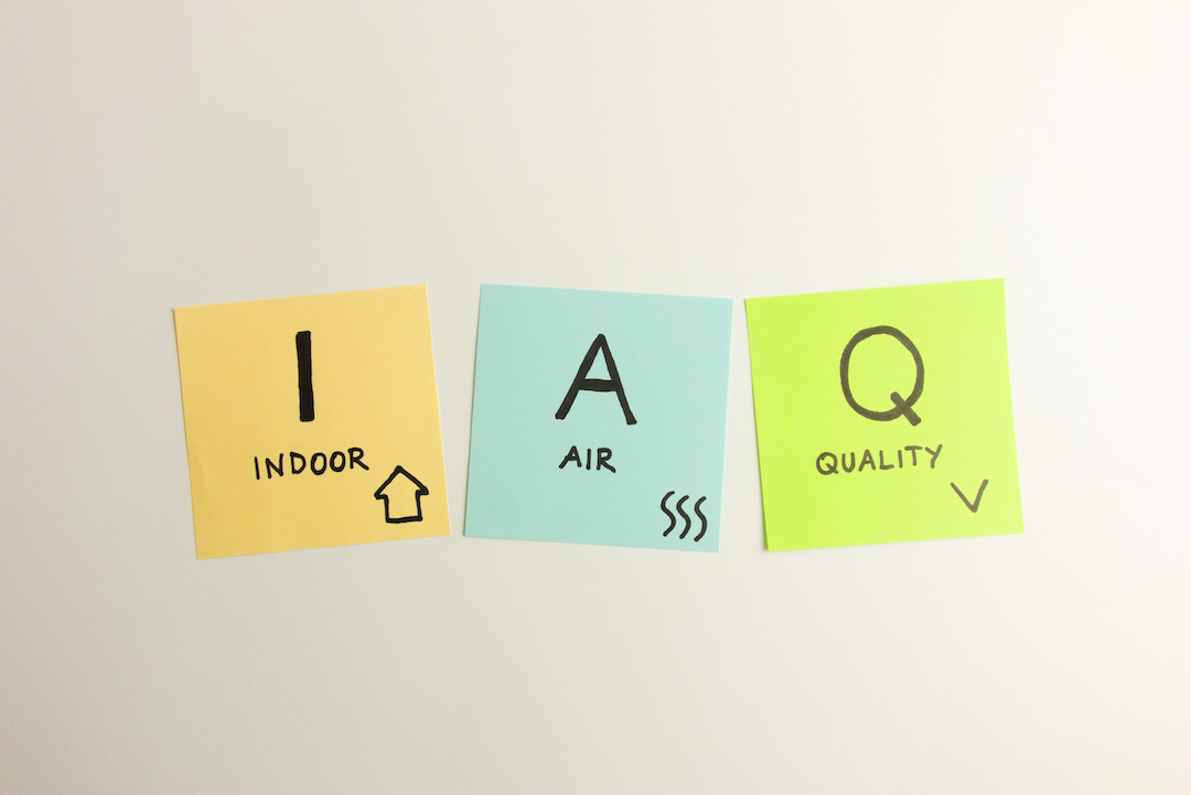 IAQ indoor air quality acronym handwritten on sticky notes isolated on white background